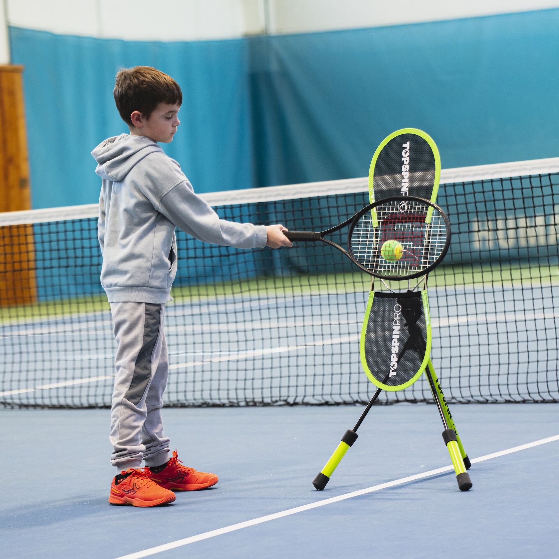 Child hitting forehand on TopspinPro