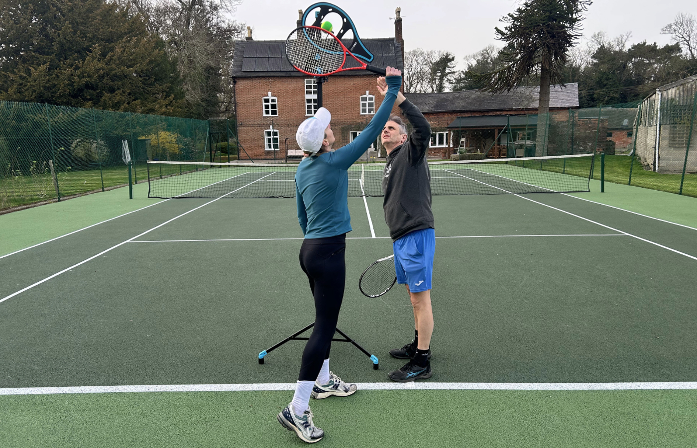 A coach demonstrating spin to a junior using the SpinPro