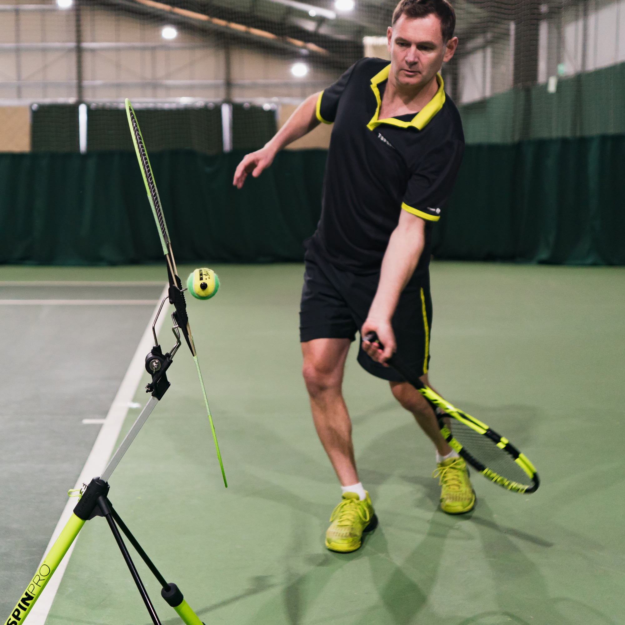Player grooving a left-handed forehand beside the TopspinPro