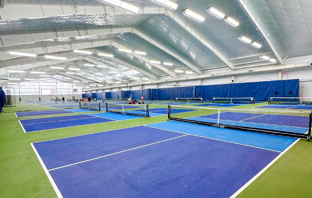 A large club group photographed on court with TopspinPro units